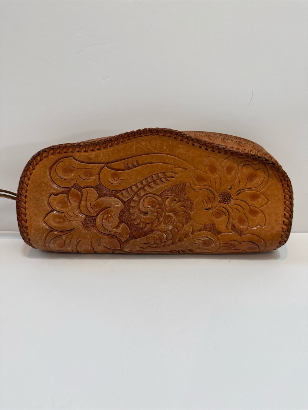 Colton’s leather hand tooled clutch wristlet